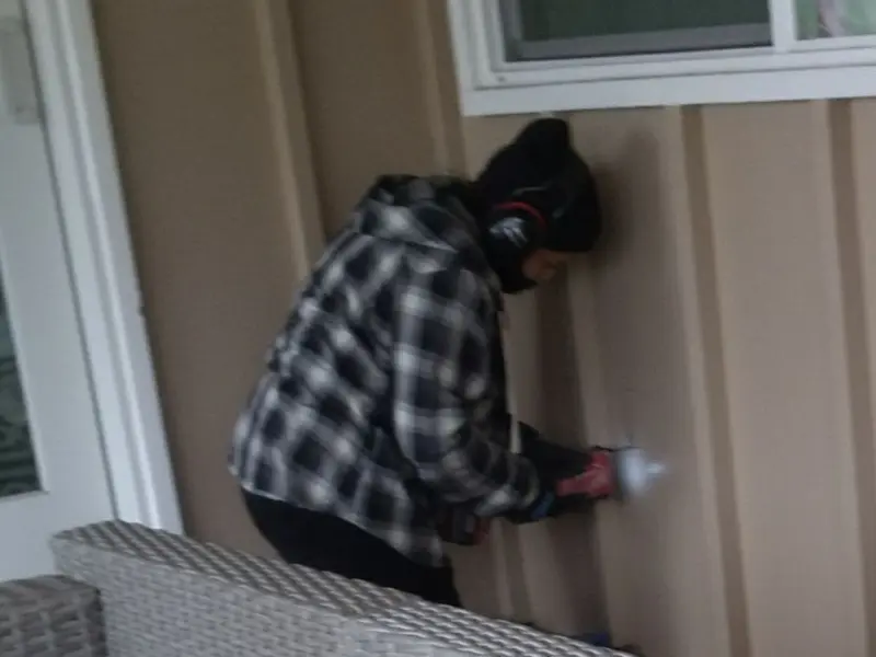 Professional electrician installing an exterior outlet in Arlington
