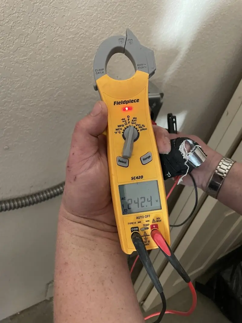 Voltage testing with clamp meter during Ceiling Fan Installation in Arlington